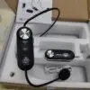 A wireless headset microphone system displayed in an open box with foam packaging. The main headset unit includes volume control buttons and a boom mic, labeled "DN-T1000" and "ETIMEK JAPAN." Also included are a compact receiver with a 3.5mm jack, a USB charging cable, a wall charger adapter, and an instruction manual in the background.