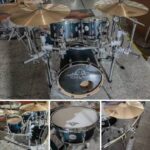 A collage of images featuring a professional Ejimek Japan acoustic drum kit. The main image shows a full setup including a bass drum, toms, floor tom, snare, and multiple cymbals mounted on a chrome rack system. The smaller images provide close-ups of individual components, including a snare drum, cymbal, and side view of the full kit.