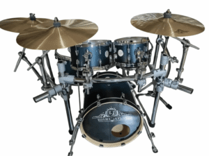 A blue drum set consisting of a bass drum, two mounted toms, and a floor tom, all with chrome hardware. The kit includes three cymbals mounted on stands around the drums. The bass drum has a logo on the front head, and the entire set is placed against a white background.